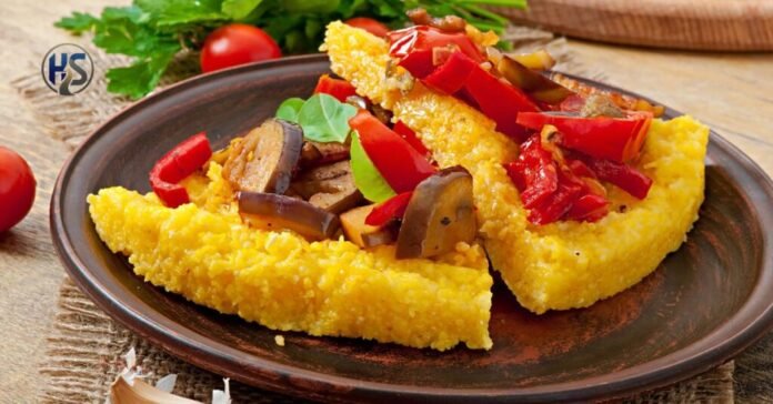 Palentu cornmeal dish topped with roasted vegetables on a rustic plate.